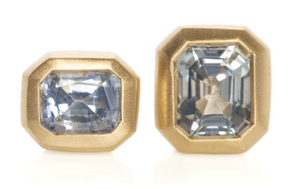 Studio shot of purpley blue sapphire and asymmetrical studs.