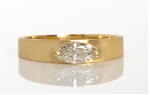 Studio shot on white of slim cigar band with diamond.