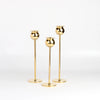 Brass Tulip Candle Holder Set of 3 three on white background.