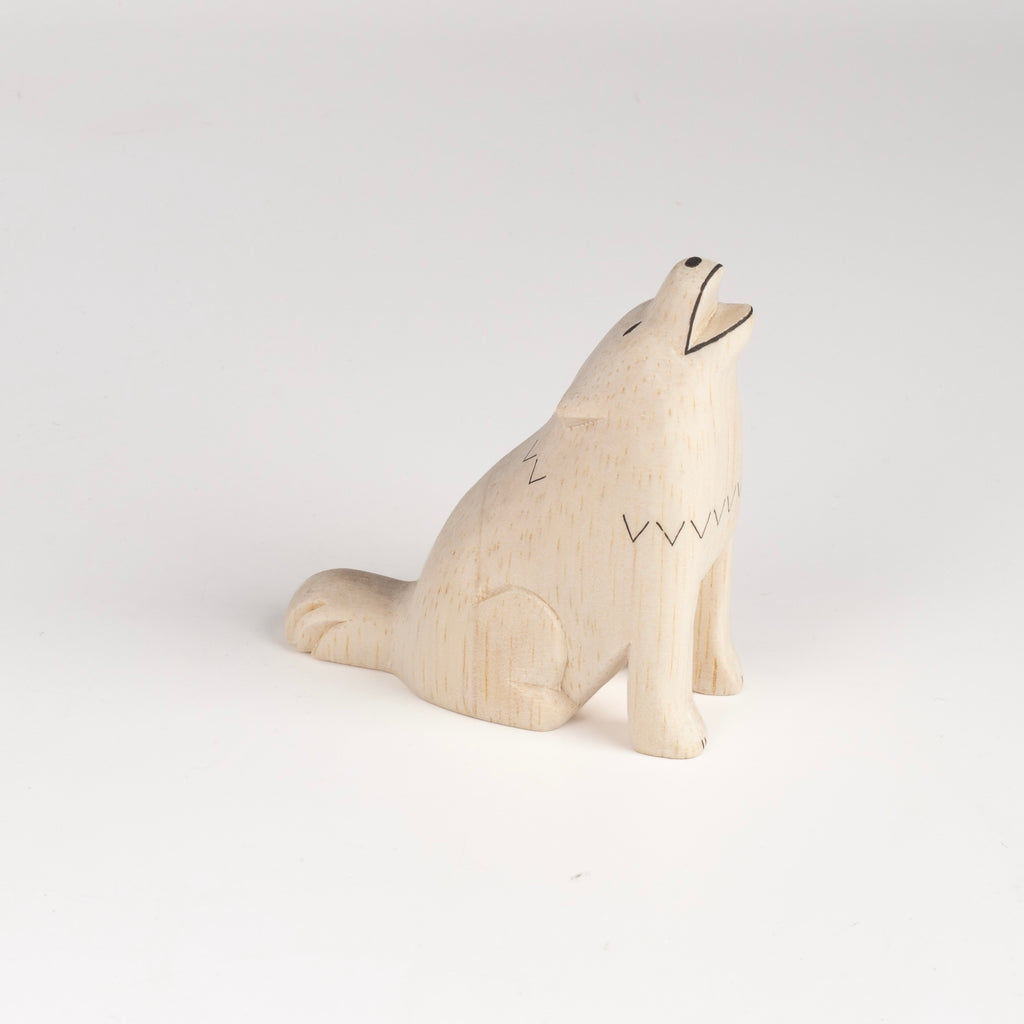 A howling wolf toy or figurine from T-lab, handmade in Bali from albizia wood, a lightweight fast-growing wood from the South Pacific. 