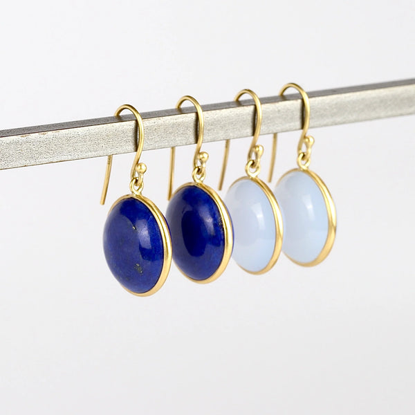 Large Moon Earrings by Tej Kothari one white background. These are cabachon stones set in 18k gold on earwire. Lapis and Chalcedony. 