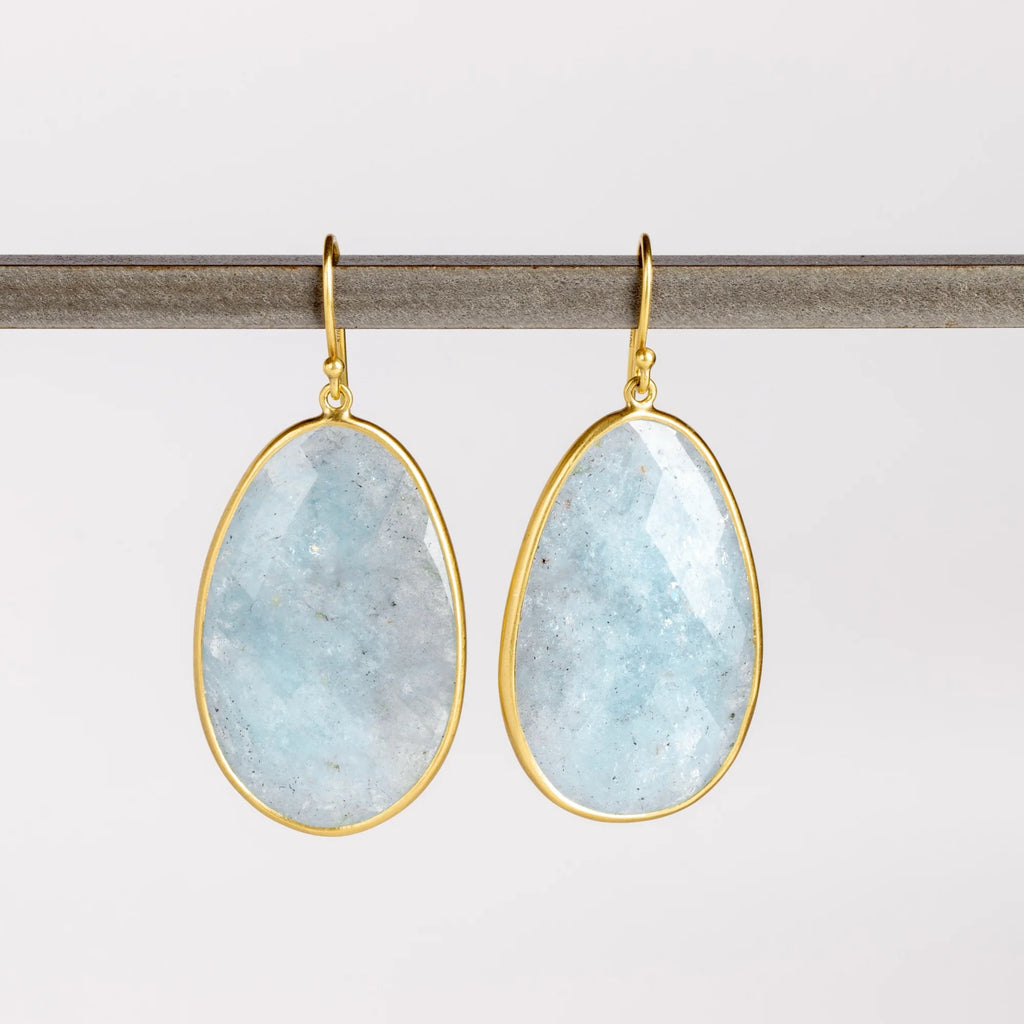XL Aquamarine Egg Earrings designed by Tej Kothari are Extra large rustic and faceted aquamarine slices, bezel set in 18k yellow gold with gold ear wire on white background.