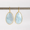 XL Aquamarine Egg Earrings designed by Tej Kothari are Extra large rustic and faceted aquamarine slices, bezel set in 18k yellow gold with gold ear wire on white background.
