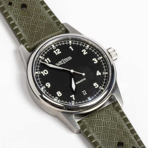 Weiss Watch 38mm Automatic Field Watch with Black Dial and date, shown with  olive rubber strap and white background.