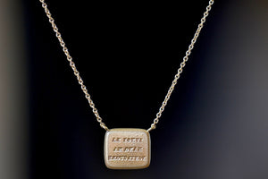 Back of Unconditional Motto Necklace designed by Makiko Wakita reads, "Lungi la mano ma non il cuore" (‘A far hand but not the heart’).