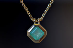 Close up of the Duo Bale Offset Emerald Necklace by Elizabeth Street Jewelry.