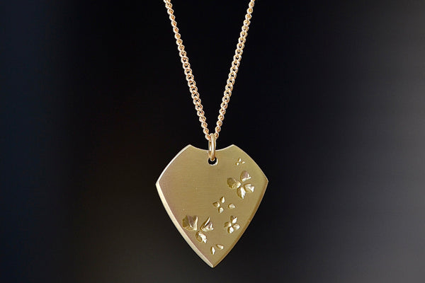 Close up of Petal Print Pick Necklace by Kaylin Hertel.