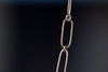 Close up of short flat clip on Kaylin Hertel's mixed paperclip chain necklace in 14k yellow gold. 