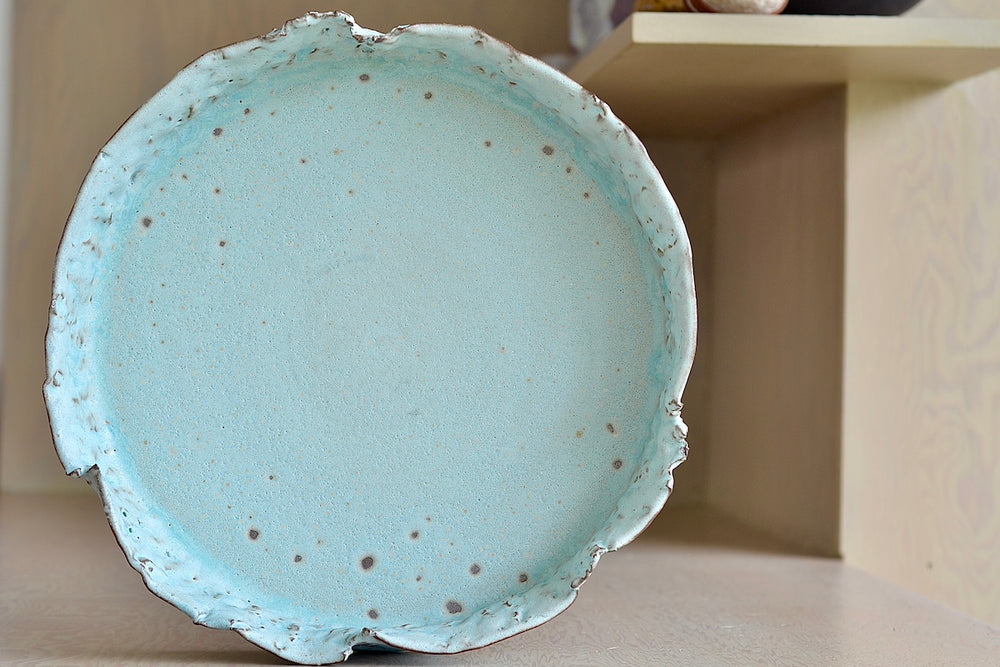 Inside of Hyejeong Kim celadon blue shallow torn bowl.