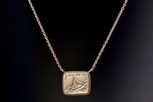 Such is Life / Forever Duo Motto Necklace designed by Makita Wakita. Made by stamping an 1800s carved seal with 'mottos' in French, Italian, Latin or English on to gold. A rectangular disc in gold with satin finish that will turn shiny over time features an image of a sailboat being tossed in stormy seas with the French phrase "telle est la vie" (‘Such is Life’ or 'that's life.’) Life might throw us in the path of storms, but like a ship on the open sea. The motto of acceptance of the unpredictable.