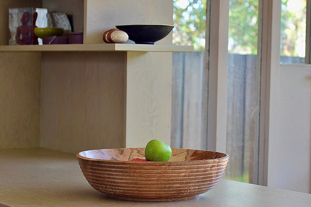 Circle Factory bowl in maple 14 x 4 with ridges on table for scale.