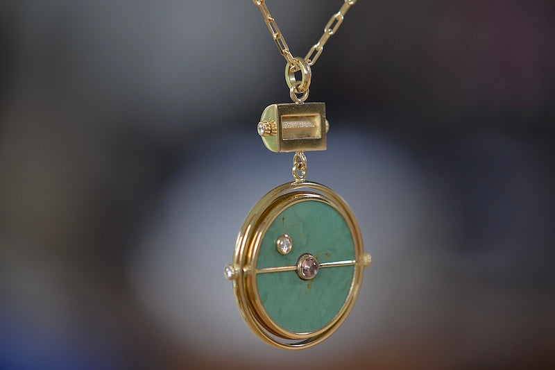Side of  Grandfather Compass Pendant in Green Turquoise and Tanzanite by Retrouvai is a pendant necklace with stone inlay that is accented with a center gem stone in the front and back, and nine (9) round white diamonds.