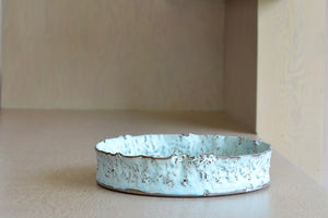 Torn Ceramic Blue Stoneware bowl is a wide and shallow ceramic torn bowl in Celadon blue glaze by Hyejeong Kim, a Korean potter currently working in Seoul and trained in both Japan and Britain, combines these three important ceramic art traditions.&nbsp; Handthrown porcelain with blue celadon glaze. Hyejeong was a Loewe Craft Prize 2020 finalist.