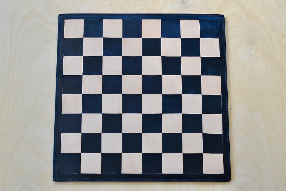 Tan and black leather chess board.