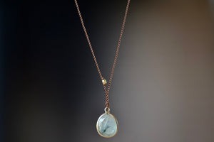 Prehnite Pendant Necklace with natural inclusions designed by Margaret Solow is an Individual translucent Prehnite stone slice with natural inclusions set in 14k gold with with a gold bead on the string makes this one of a kind &nbsp;organic pendant necklace. Designed by Margaret Solow. 