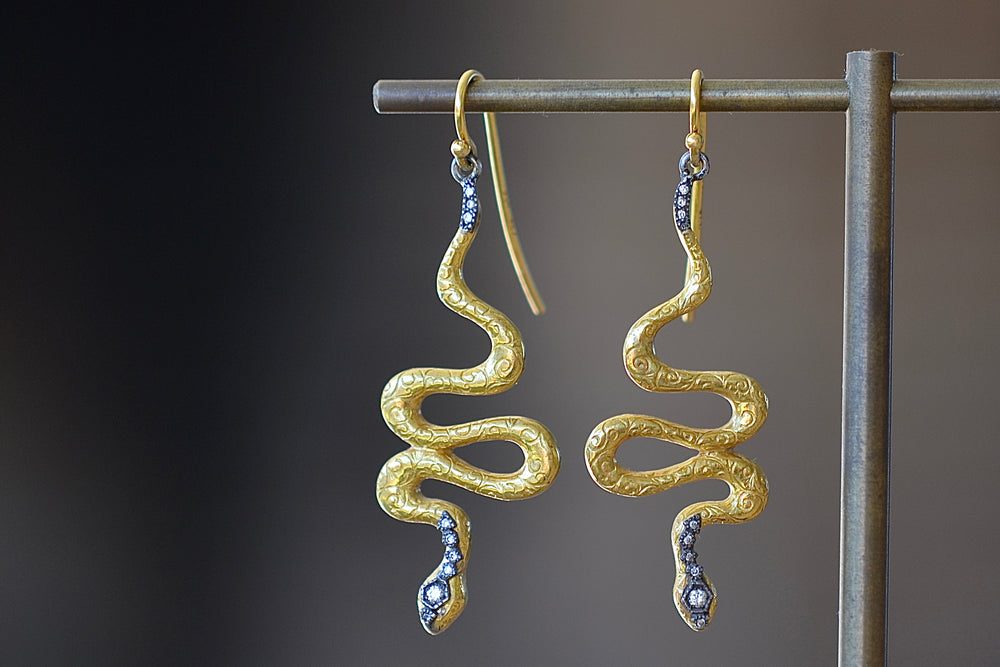 Snake Drop Earrings by Arman Sarkyssian are 22k gold snakes with oxidized sterling silver details, accent  pavé diamonds and engraved details on earring hooks. 