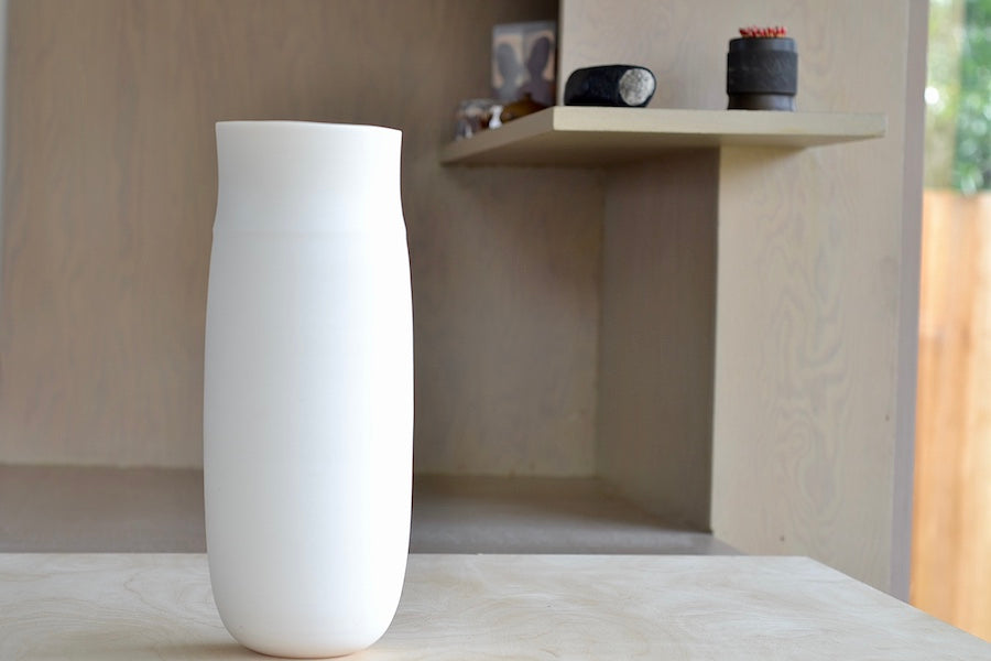 Lilith Rockett Tall vase is reminiscent of an eggshell. It is hand thrown porcelain with gloss glaze on the interior and an unglazed exterior that has been sanded smooth and it is very stable despite its rounded bottom. Handmade in Portland, Oregon. 