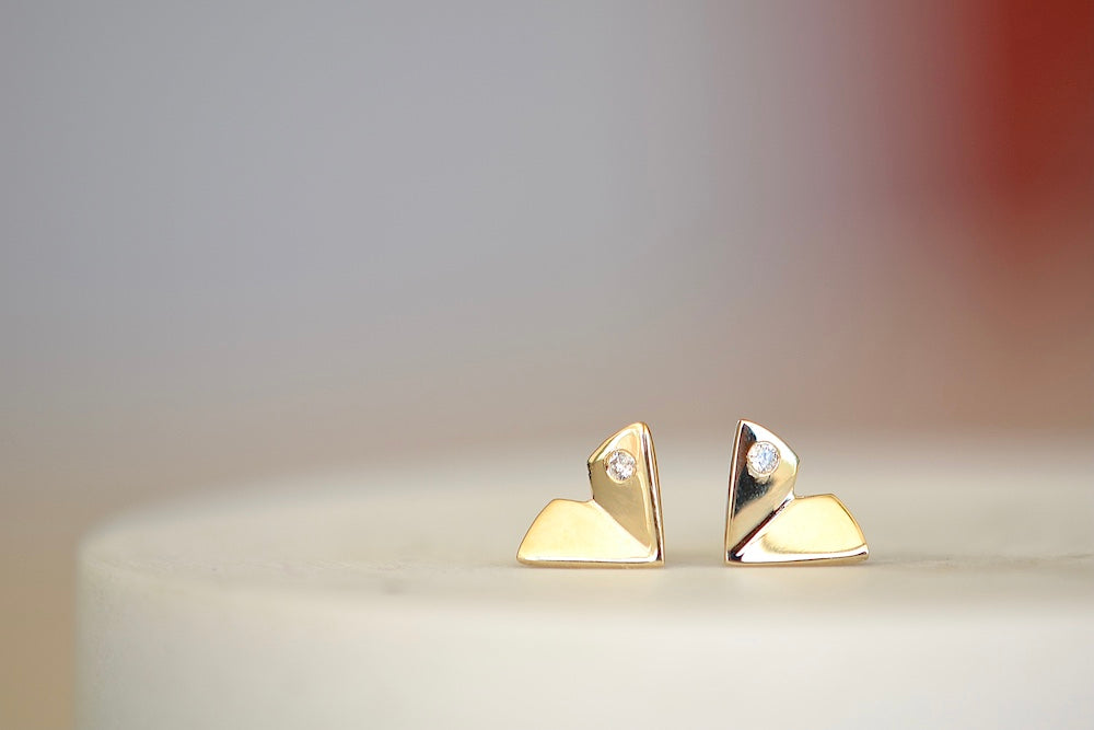 Large Origamin Stus with diamonds by Kaylin Hertel are Perfectly minimal gold origami bird studs in 14k yellow gold with one diamond each.