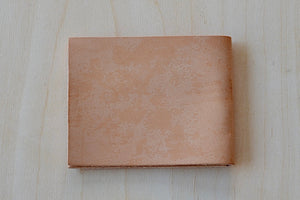 Simple Flap wallet in Natural leather and natural stitching from architect Alice Park shown closed.
