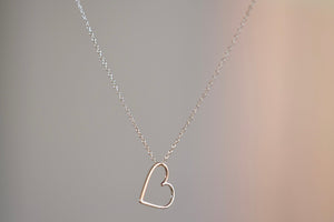 Hortense Sweet Heart Necklace is a heart shaped charm sits loose on a whisper thin 14k yellow gold chain. Very sweet. Handmade in Los Angeles.