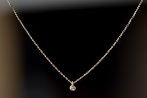 Dainty Necklace with Diamond by Carla Caruso is a forever necklace of a simple and sparkly white diamond bezel set in 14k yellow gold and satin finish on a chain. Handmade in Massachusetts.