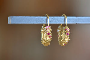 Polly Wales Coeur de Dentelle Padlock Earrings 18k yellow gold filagree padlock earrings with rich pink sapphires and a matte finish. Hinged ear wire closure