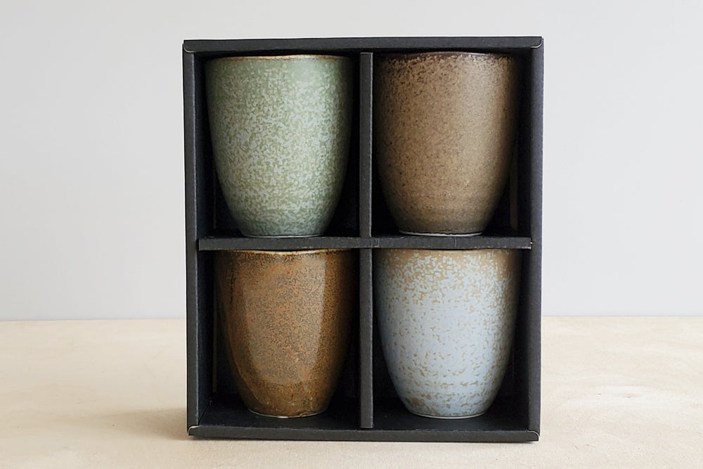 Set of 4 ceramic Japanese cups in a box.