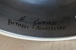 Signature on black vase.