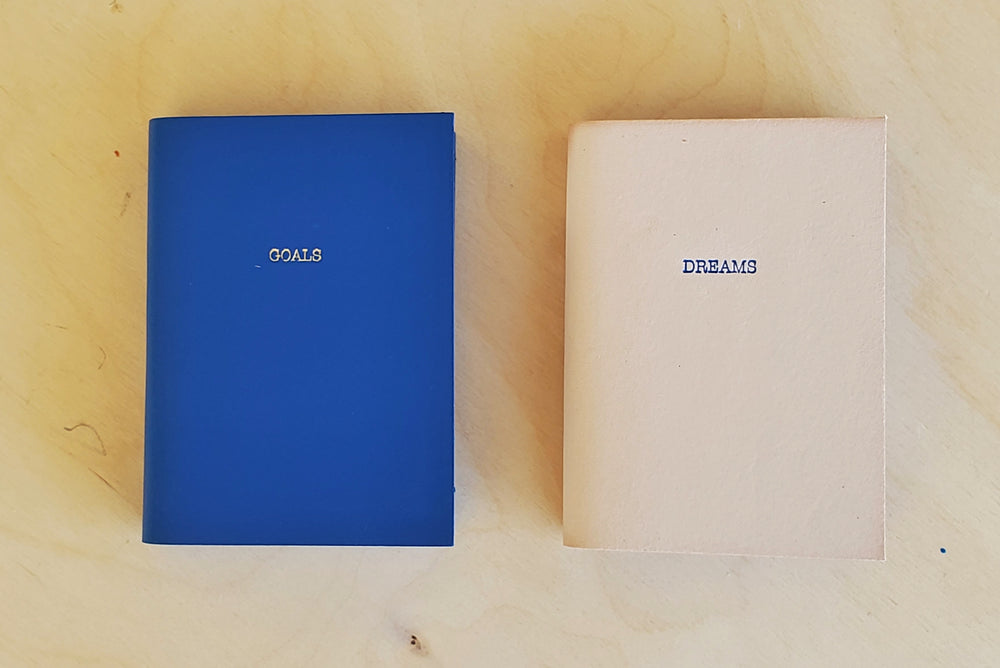 Leather Raw Edge Small Journal with Goals or Dreams printed on the front.