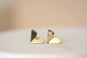 Large Origamin Stus with diamonds by Kaylin Hertel are Perfectly minimal gold origami bird studs in 14k yellow gold with one diamond each.