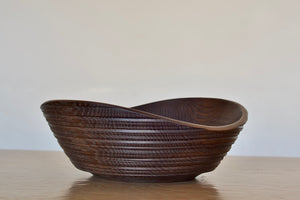 Circle Factory Brown Bowl in Black Oak with ridged detail with white background. Made and designed by George Peterson. 