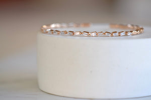 Suzanne Kalan Zig Zag Flexible Diamond Baguette Bangle Shimmering and bezel set white baguette diamonds are mixed with solid gold shaped baguettes on a thin and flexible rose gold cuff in 18k rose gold.