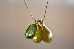 Colette Duo in Green Tourmaline and Lemon Quartz by Pippa Small is a A duo of bezel set, lightly faceted and translucent stones in green Tourmaline and Lemon Quartz that are accompanied by a gold bead and hang on a 17" golden waxed silk cord to form this necklace. 