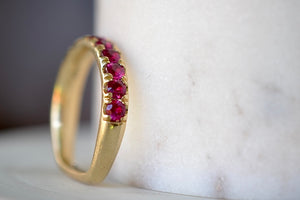 Euro Wedding Band in Ruby by Elizabeth Street is a rose cut half eternity euro band made out of hot pink magenta rubies set into this unique band that is made for stacking, 14k gold band that has a nearly flat back or underside for ultimate comfort.  Handmade in Los Angeles.