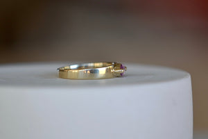 Stoned Slim Cigar Band in purple to lilac Sapphire size 6.5 by Elizabeth street is a marquise cut sapphire in a two prong eagle claw bezel setting on a 14k yellow gold band.