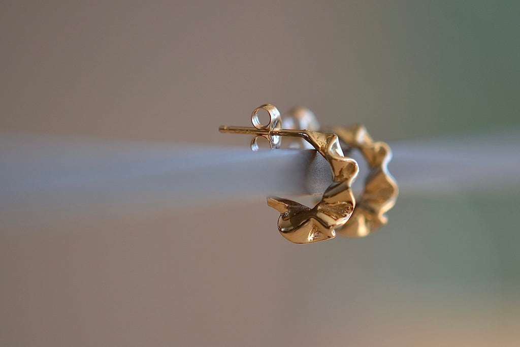 Ruffle Huggie Earrings by Kaylin Hertel arePerfectly minimal pleated and pleated gold squiggle huggie hoop earrings in 14k yellow gold with post closure.