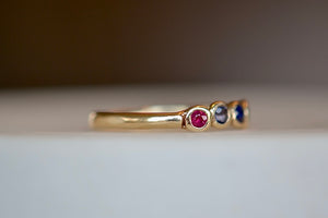 Close up on organic narrow band and Ruby on 14k gold Rise ring by Makiko Wakita.