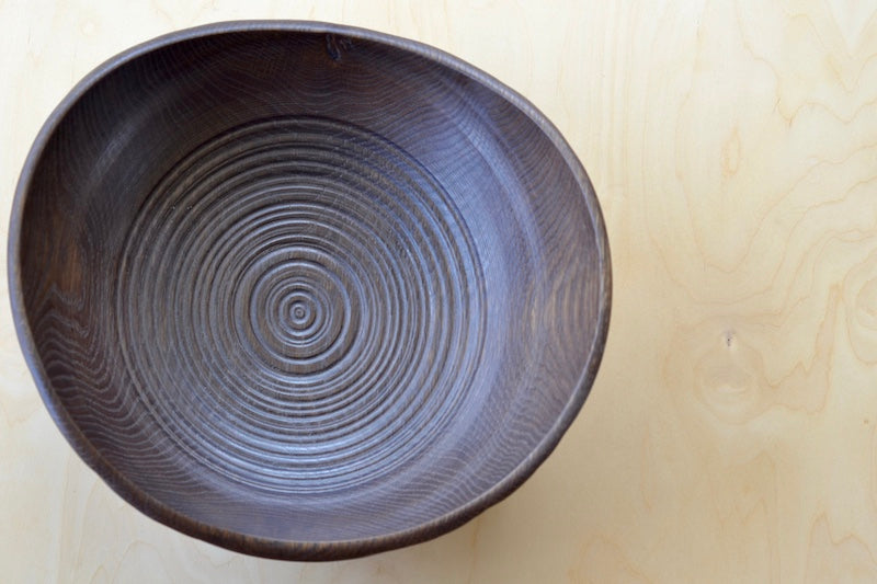 Birds eye view of Circle Factory Brown Bowl in Black Oak with ridged detail. Made and designed by George Peterson. 