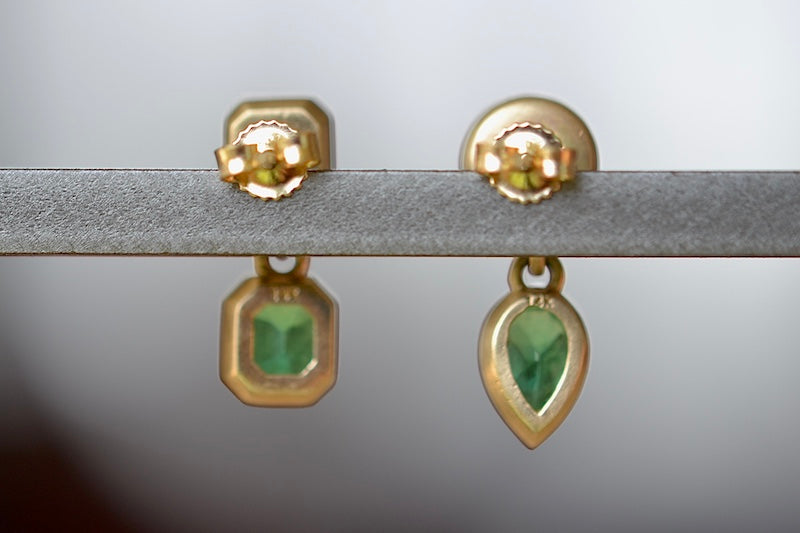 Asymmetric Duo Emerald Earring by Elizabeth Street are bezel set mixed shape and mismatched earrings with post closure in deep green Columbian Emeralds sold as a pair and handmade in Los Angeles.  