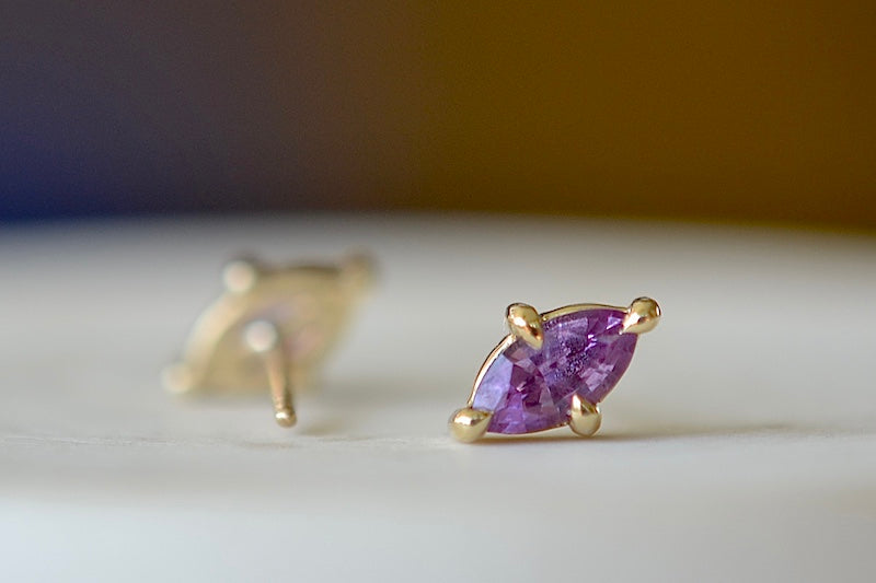 Eagle Claw Stud Earrings in Purple Sapphire by Elizabeth Street Jewelry are Marquise Sapphire Stud Earrings in violet purple to lilac that are bezel set marquise cut sapphires in a four prong eagle claw setting with post closure in 14k satin gold form these elegant everyday studs.