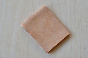 Simple Flap wallet in Natural leather and natural stitching from architect Alice Park shown closed.