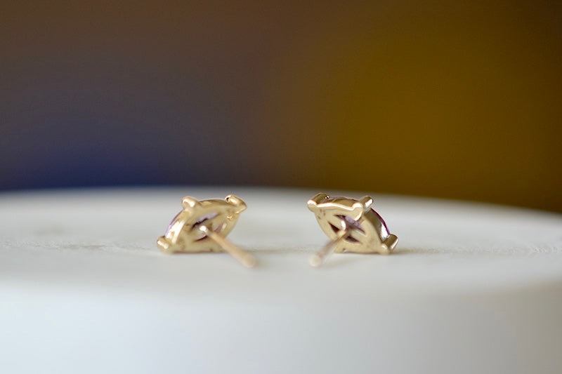 Eagle Claw Stud Earrings in Purple Sapphire by Elizabeth Street Jewelry are Marquise Sapphire Stud Earrings in violet purple to lilac that are bezel set marquise cut sapphires in a four prong eagle claw setting with post closure in 14k satin gold form these elegant everyday studs.