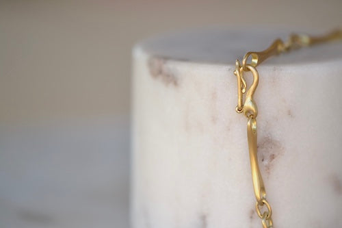 Marian Maurer City Bar Link Bracelet is a curved bone link in her signature smooth and silky 18k yellow gold with satin finish that honors New York City and cities.. This bracelet has a hook and eye closure with a safety to stay on forever.