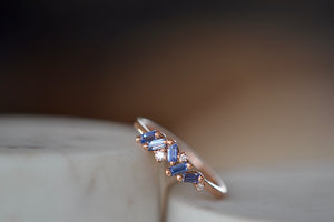 Suzanne Kalan Sapphire Mini Cluster Ring BAR848 RG. A cluster ring made up of five shimmering sapphire baguettes and three round white accent diamonds set in a signature fireworks setting on an 18k rose gold band. 