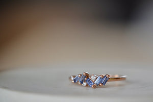 Suzanne Kalan Sapphire Mini Cluster Ring BAR848 RG. A cluster ring made up of five shimmering sapphire baguettes and three round white accent diamonds set in a signature fireworks setting on an 18k rose gold band.