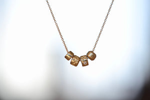 Four (4) bead necklace in 14k gold with Canadian diamonds by Kaylin Hertel.