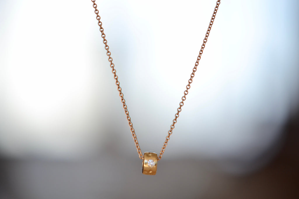One (1) bead necklace in 14k gold with Canadian diamonds by Kaylin Hertel.