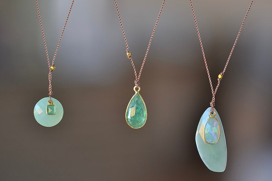 Faceted Emerald Pendant Necklace by Margaret Solow is An Individual or two faceted Emerald stone slice set in 18k gold with with a gold bead on the string makes this one of a kind  organic pendant necklace.  Green Chalcedony and Emerald and Green Chalcedony and opal.