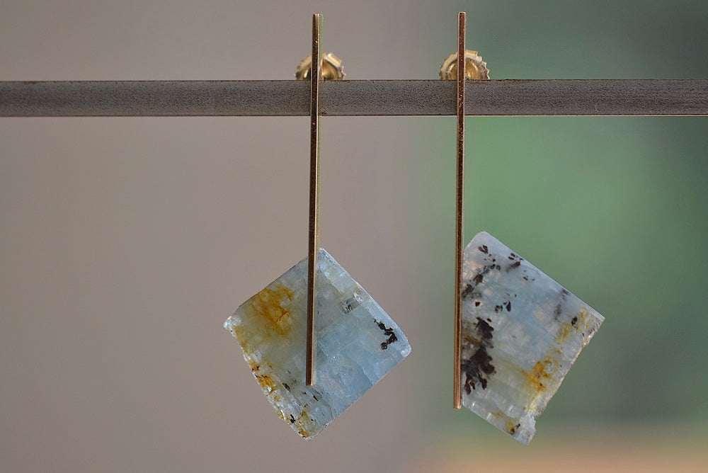 One of a kind asymmetrical aquamarine stone earrings stones with natural inclusions attached to Kathleen Whitaker's signature elongated gold plate studs with post closure. Stone Collection.