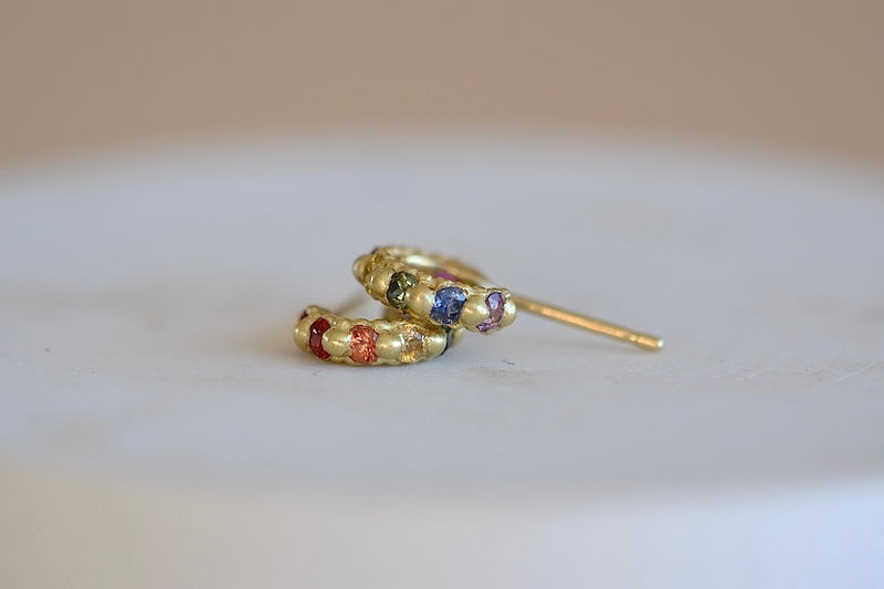 Polly Wales Rapunzel Ear Cuffs huggie buggies 18k yellow recycled gold pink, red, orange, yellow purple, blue and green sapphires and a matte finish. Cast not set.